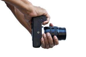 primer plano aislado fotógrafo tailandés masculino dedos sosteniendo una cámara de película dslr. foto