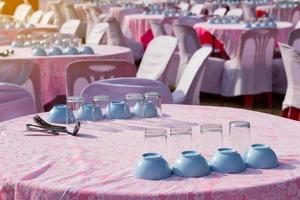 Glasses and cups are placed on tablecloths. photo