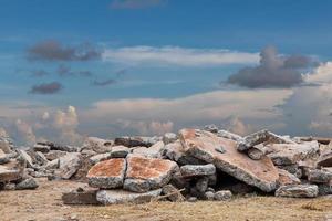 Stack of concrete debris with sky clouds. photo