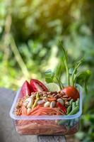 Papaya chopped and herbs vegetables in a box to salads. photo