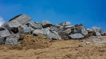 A low, close-up view of a large pile of concrete rubble from demolition roads. photo