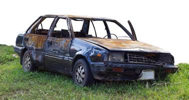 el coche aislado está quemado, estacionado en el césped. foto