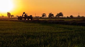 Walking tractors on the road with sunsets in the evening. photo