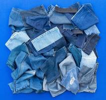 Pieces of cloth jeans on a blue background. photo