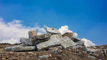 A low angle view, the rubble of large concrete blocks is piled up on the mounds. photo