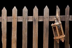 Old wooden fence and hanging lamps. photo