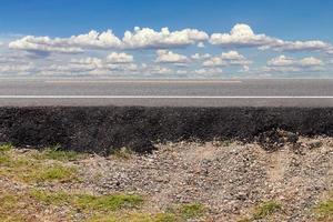 Side view of paved road with sky clouds. photo