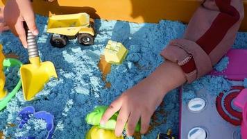 children's creativity, kinetic sand games with various forms of mold. top view video