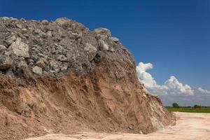 Underneath the ground, dig and pile the rocks with skies. photo