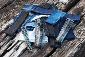 Jeans pieces on old wood. photo