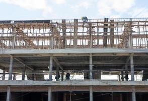 A view from below to the construction of a rowhouse building anchored. photo