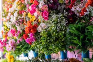 Many colorful artificial fake flowers background blooming beautiful. photo