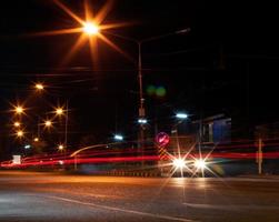 Car headlights and night street lamps. photo