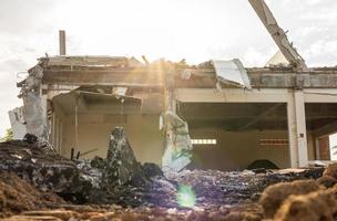 Low view of the ruins of the buildings against the flare of the afternoon sun. photo