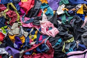 The background of the rag pieces of various colors are stacked together in a scattered mess. photo