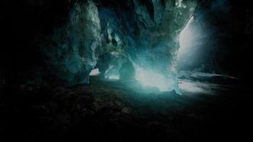 blue ice cave covered with snow and flooded with light video