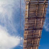 Under the wooden bridge with sky clouds. photo