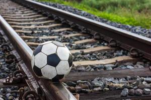 Close-old football on the tracks. photo