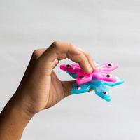 Hand star spinner in fingers. photo