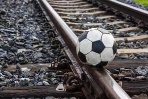 Close-old football on the tracks. photo