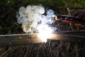 Sparks and smoke welding iron. photo