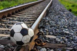 Close-old football on the tracks. photo