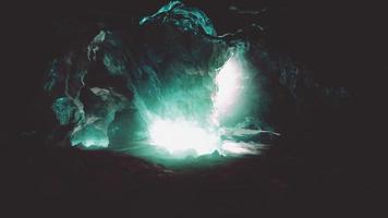 blue ice cave covered with snow and flooded with light video