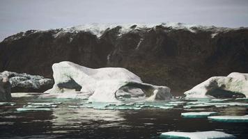 Blue icebergs of Antarctica with frozen and snow covered Antarctic scenery video