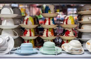 A group of ceramic cups painted in red patterns stacked on top of each other. photo