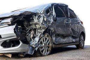 Low side view of a sedan that was smashed in a fatal collision. photo