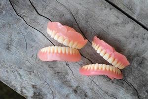 The dentures were left on the old wooden floor. photo