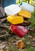 Small, old gallon buckets are hanging and stored for reuse. photo