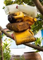 Small, old gallon buckets are hanging and stored for reuse. photo