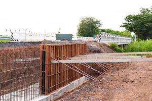 Formwork for the concrete to prevent water erosion along the road. photo