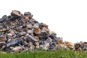 Isolate pile of granite stones with grass weeds. photo