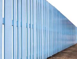 Side view, old wooden fence painted in beautiful blue color. photo