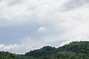 Green mountain with cloudy skies. photo