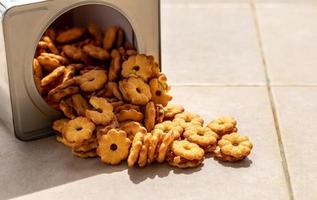 Many pineapple biscuit desserts are stacked on the concrete floor. photo