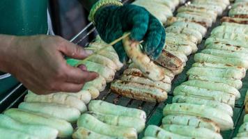 Hand and grilled bananas on the grill. photo