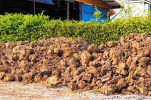 Mound of soil near the fence of the house. photo