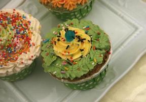 Closeup of assorted flavors of decorated cupcakes photo