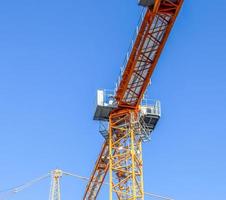 Several cranes on constructions sites at high buildings all over Europe photo