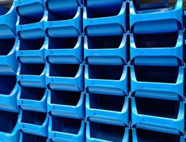 Stacked blue plastic boxes for sale in a hardware store. photo