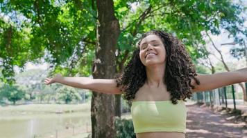 Attractive Latin woman walking in the park on a sunny day and smiling. photo