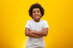 African American boy with black power hair on yellow background. Smiling black kid with a black power hair. Black boy with a black power hair. African descent. photo