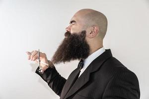 barber with long beard using scissors photo