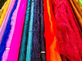 Samples of cloth and fabrics in different colors found at a fabrics market. photo