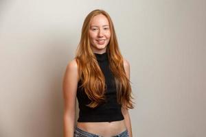 Portrait of beautiful cheerful redhead girl smiling laughing looking at camera over white background. photo