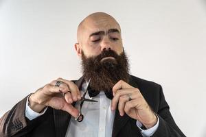 barber with long beard using scissors photo