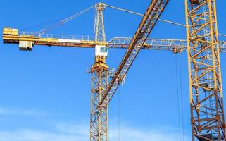 Several cranes on constructions sites at high buildings all over Europe photo